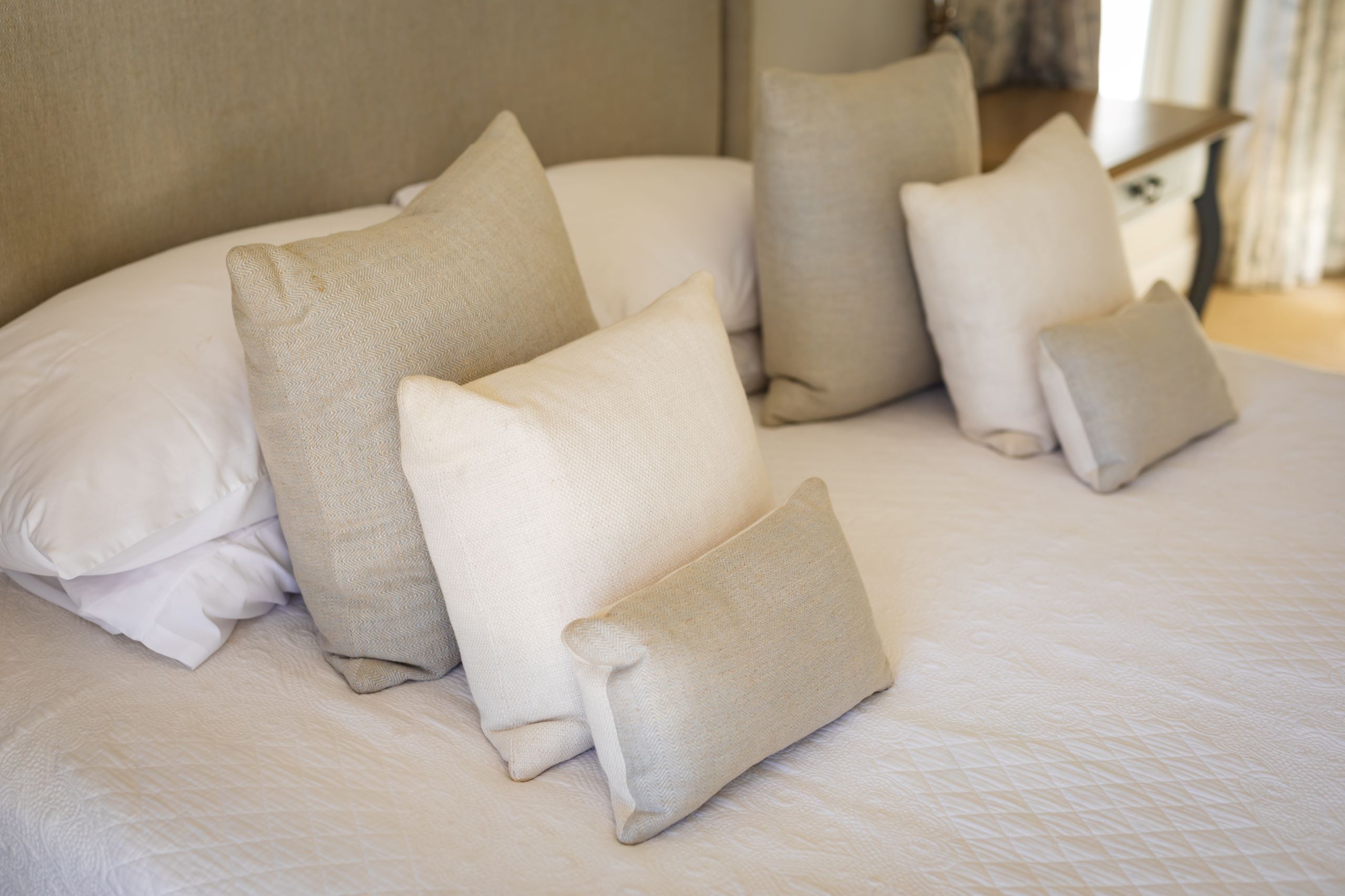 close up of beige and white cushions and pillows o 2025 04 03 10 48 12 utc